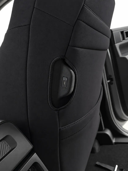 Kia Tasman X-Line neoprene car seat covers rear view of drivers charging port